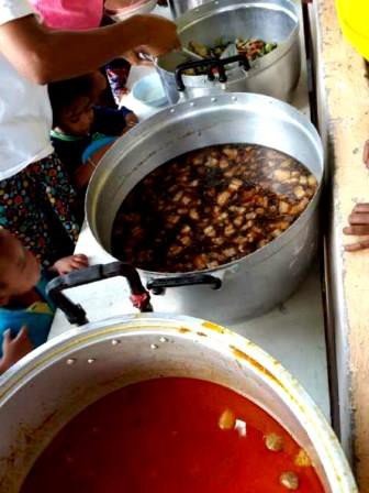 Big pots of festive food being cooked and served for the Christmas feast