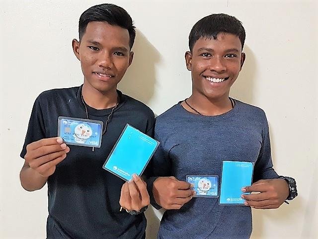 Two of the older boys holding their new bank books