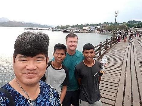Philip, Wud and Tine with a friend on the long wooden bridge at Sangkhlaburi