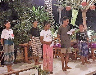 Wud and Jieab telling the Moken story in English on stage at the Peacock Tree fundraiser