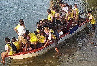 The children boarding the long-tail boat for the monthly church service on Koh Chang