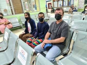 Philip waiting at the terminal with two of the young men as Wud set off north for mission training