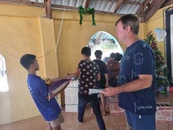 Christmas gifts being handed out one by one in the church