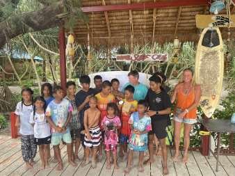 The island children lined up with surfboards at the Moken Surf Club