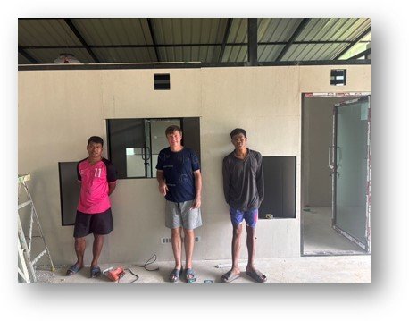 Three of the team inside the nearly finished factory building